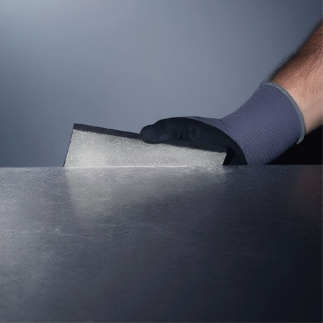 Hand using Bihui Rectangular Diamond Hand Polishing Pad on a metal surface for polishing.