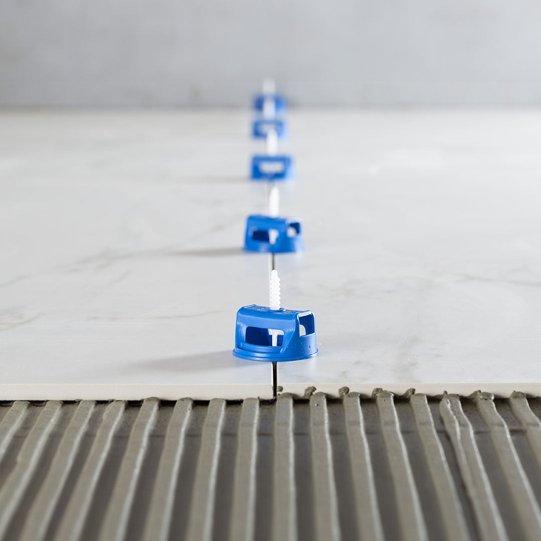 Mapei MapeLevel Easyclick Cap in use for leveling ceramic tiles with a fast-screwing system.