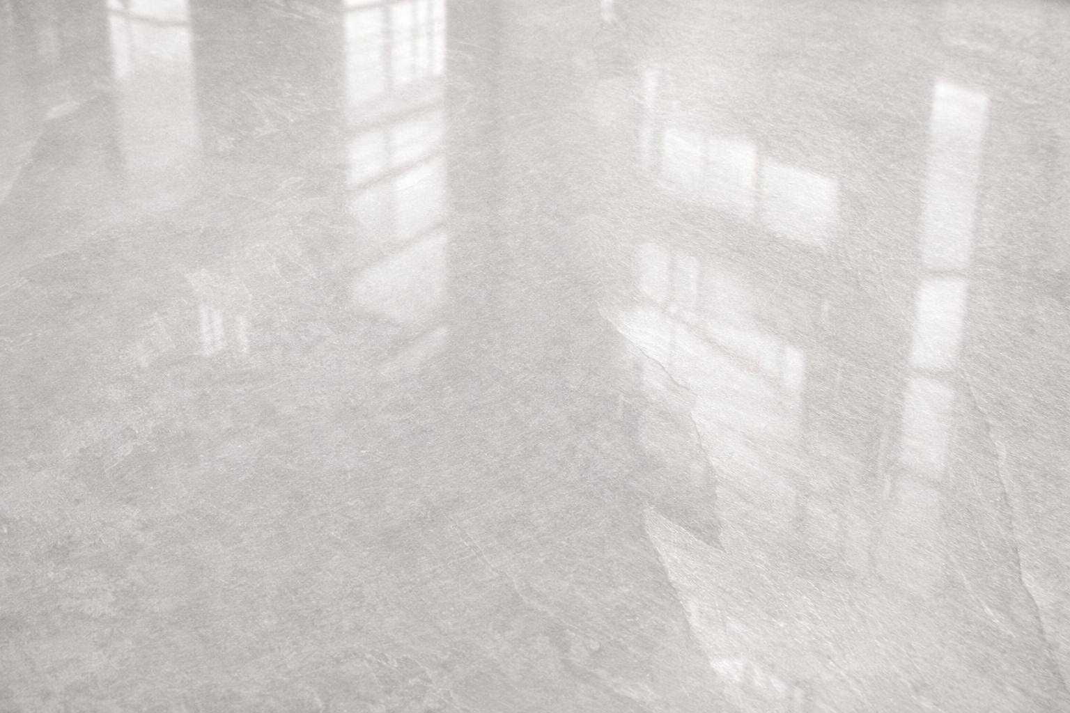 Close-up of Spirit Ice polished tiles showcasing their elegant, silvery finish reflecting light beautifully.