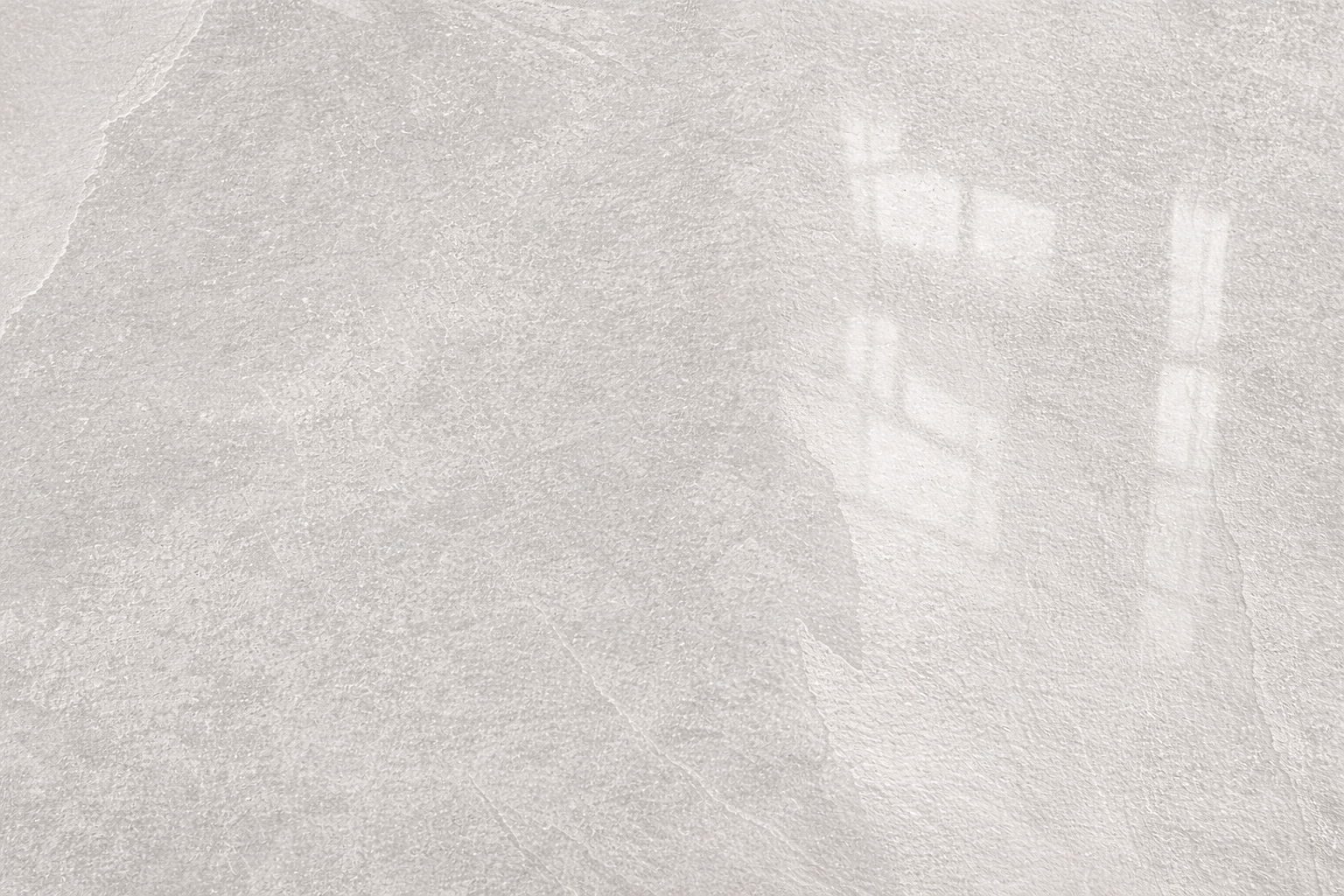 Spirit Ice polished tile in pale gray showcasing elegant reflections and texture.