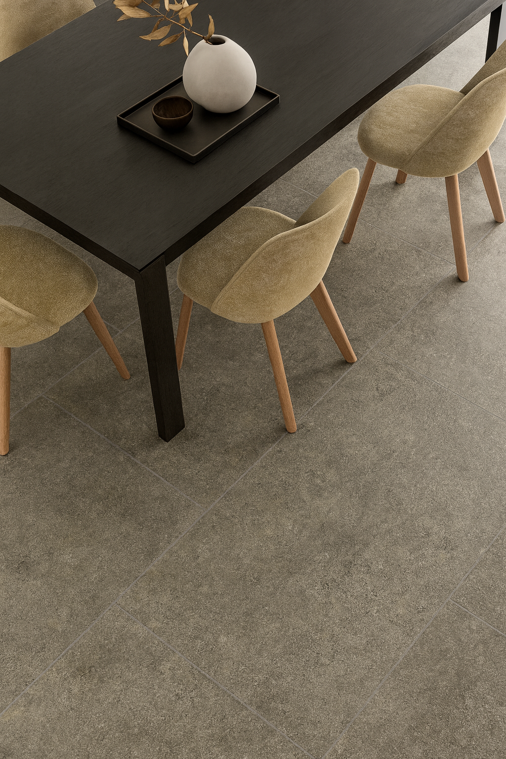 Lore taupe porcelain tiles featured under a modern dining table with beige chairs.