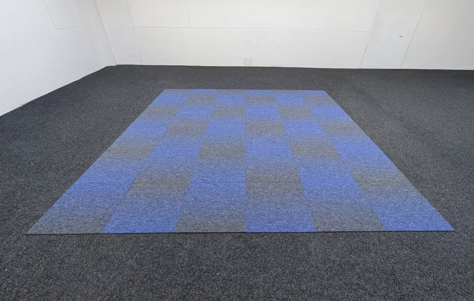 Burmatex Tivoli Mist Nordic Fjord Carpet Tile in blue and gray colors arranged in a checkerboard pattern.