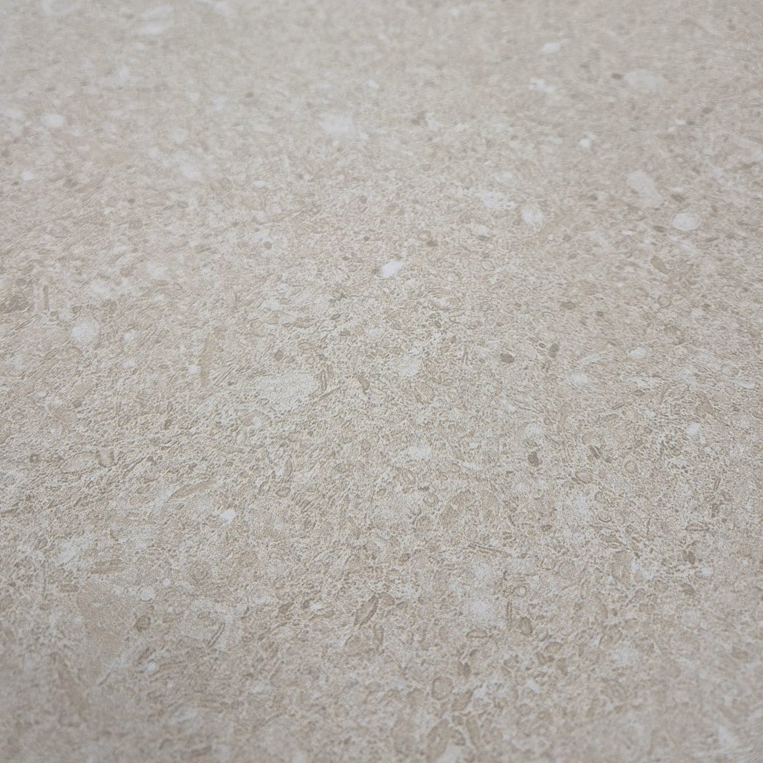 Close-up of Ette Natural surface displaying warm sandy hues and organic texture.