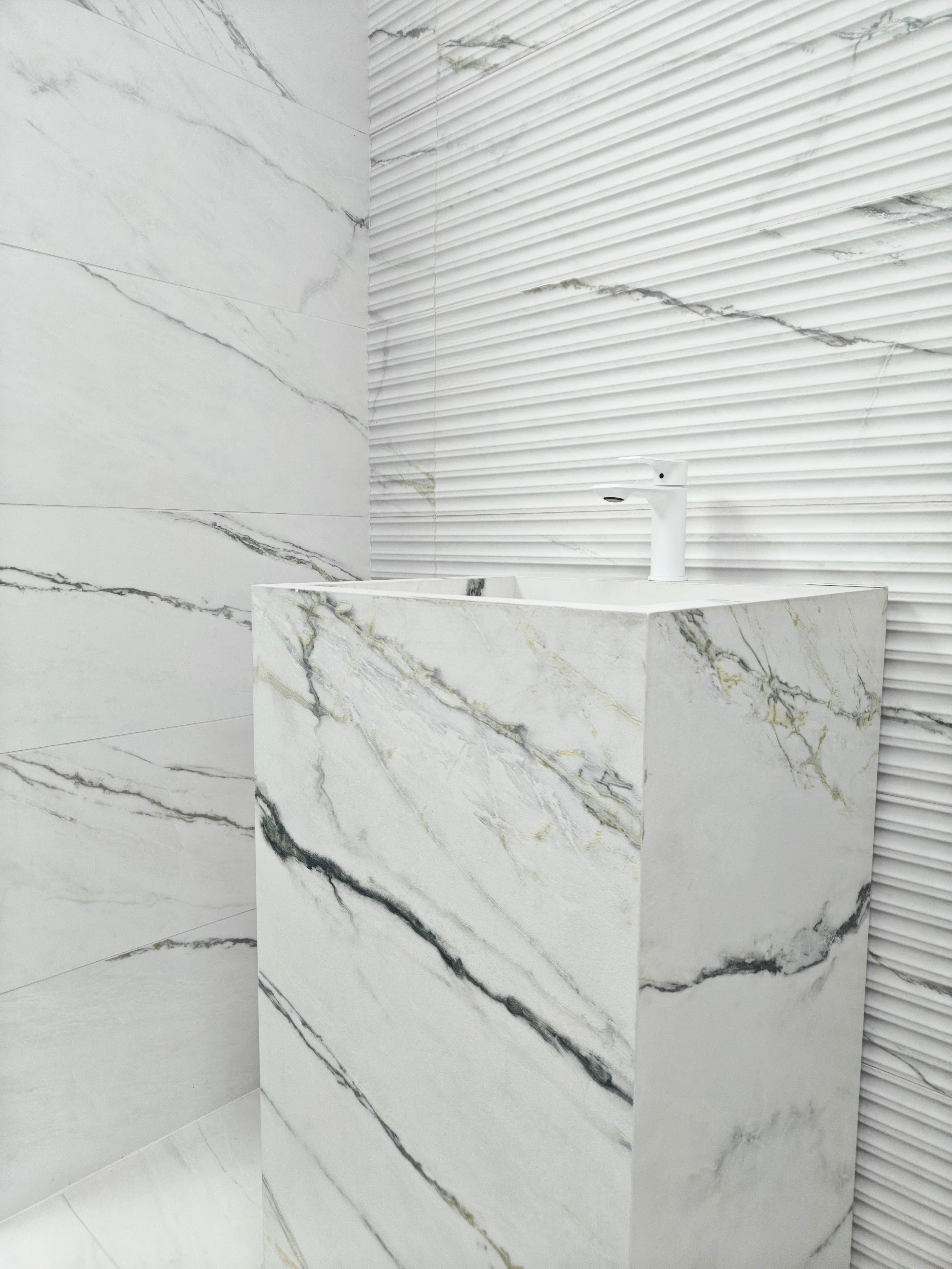 Calacatta Green ceramic wall tile featuring a sleek modern sink in a stylish bathroom.