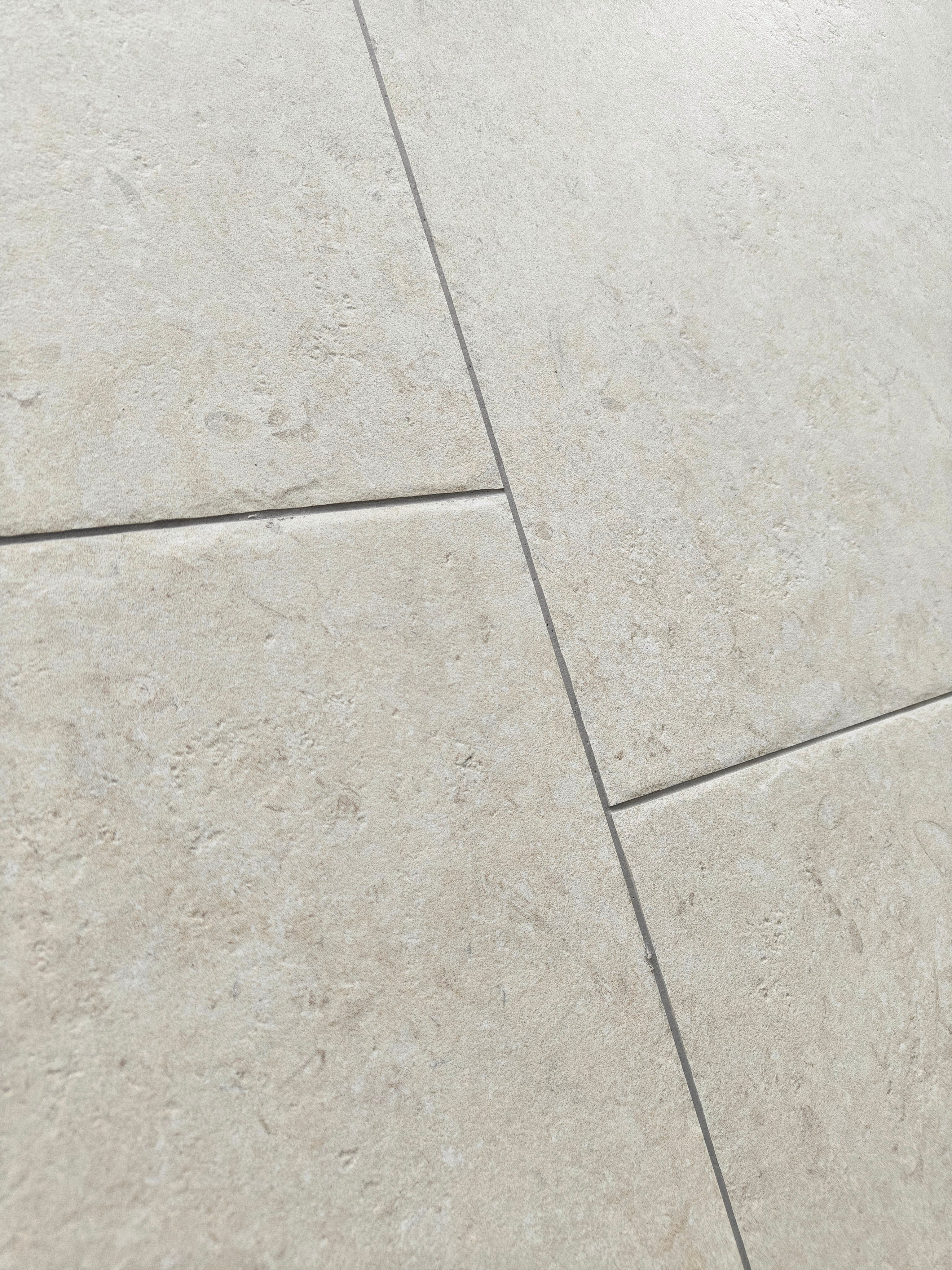 Castleton Ivory porcelain tiles with subtle stone-like texture in ivory tones, ideal for elegant interiors.