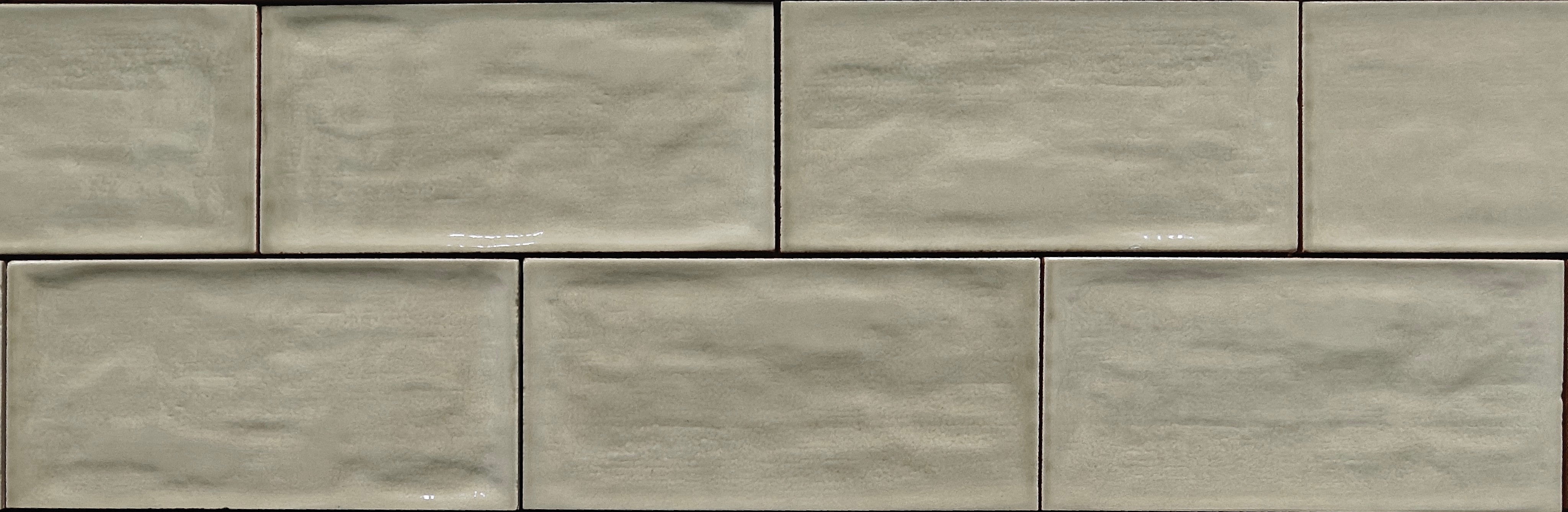 Rustico avocado gloss ceramic wall tile 7.5x15cm with soft tonal variations and a gently undulating surface.