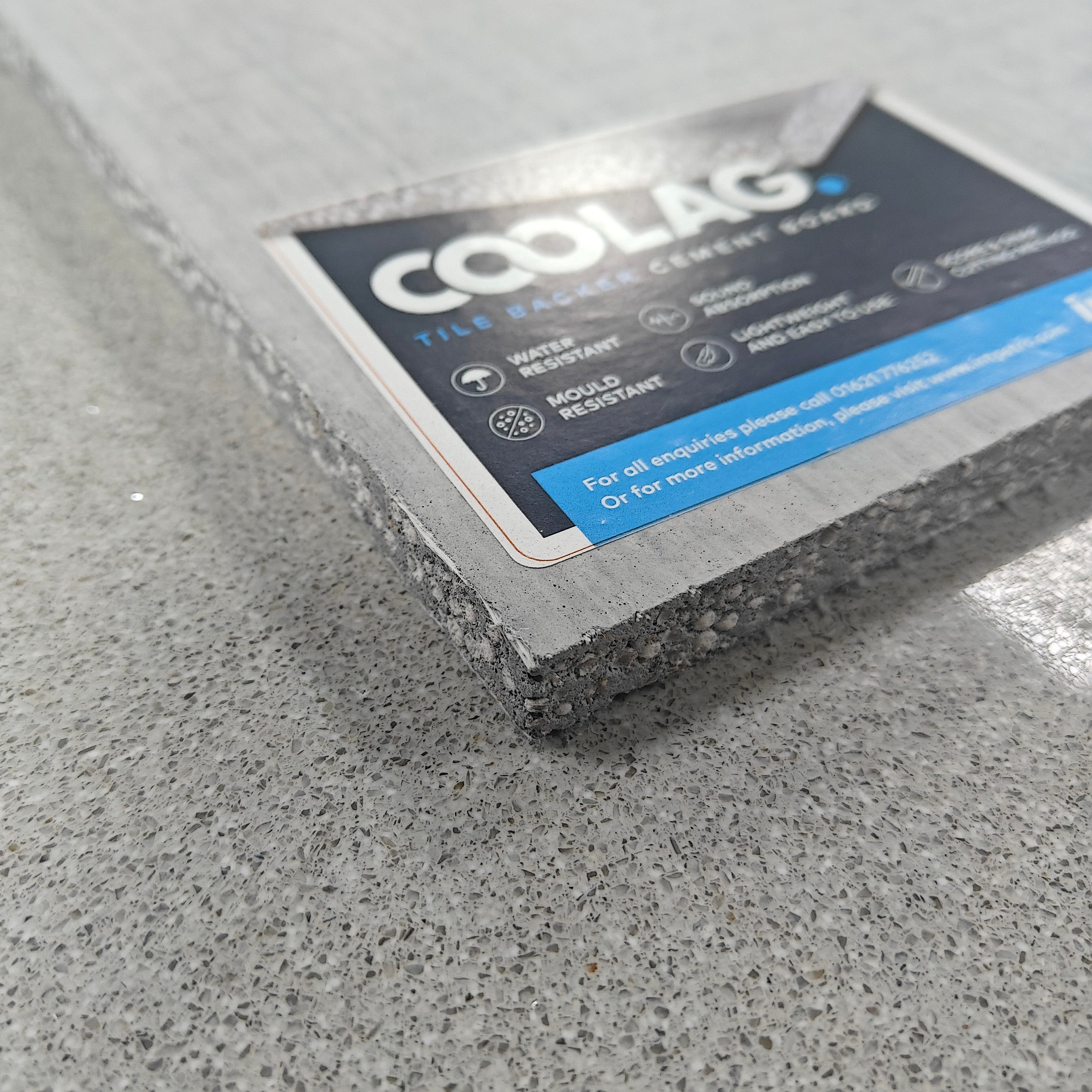 Coolag Lightweight Cement Board 6mm with label showing features and benefits on a grey textured surface.