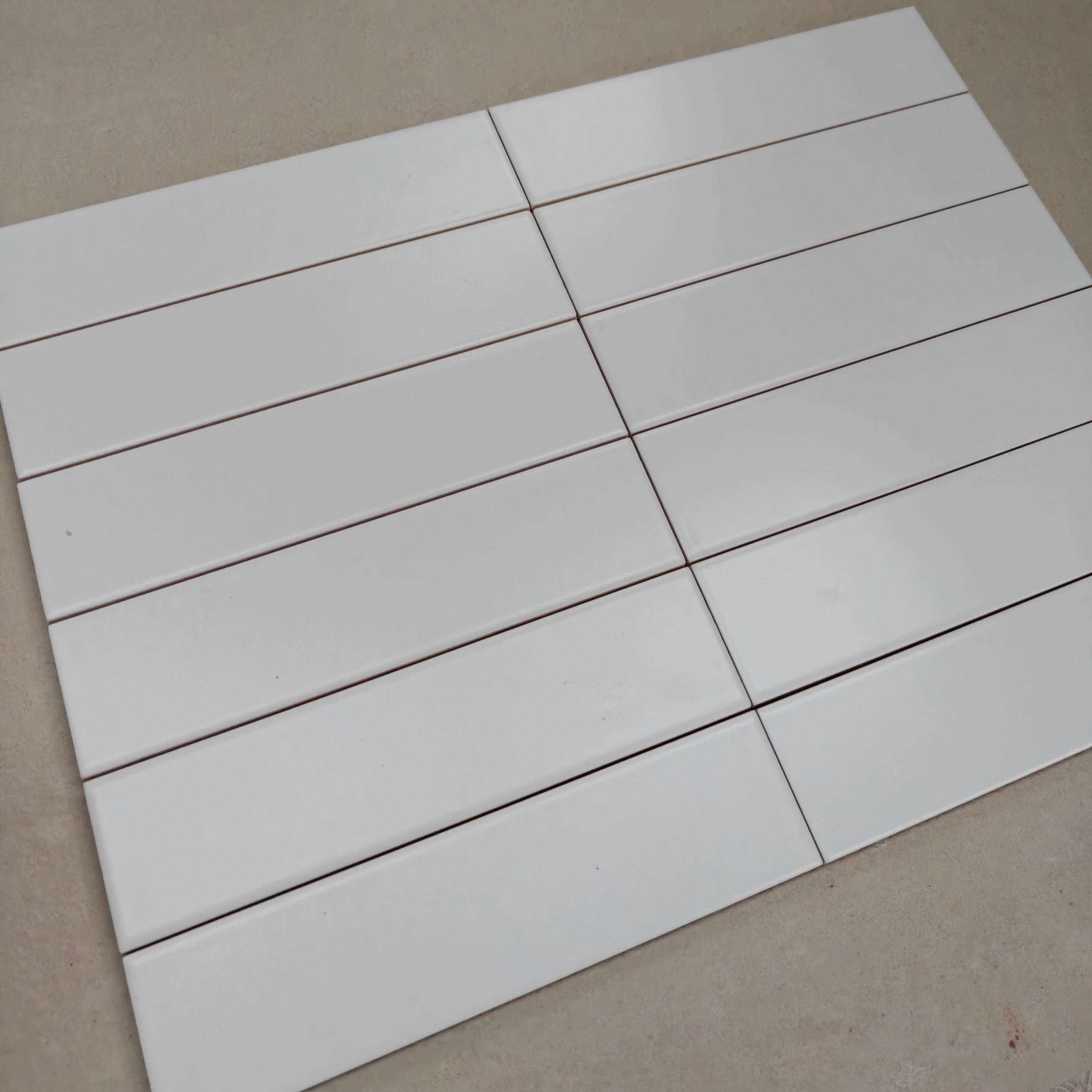 Evolution Matt Blanco ceramic wall tiles arranged in a sleek layout, showcasing their glossy white finish.