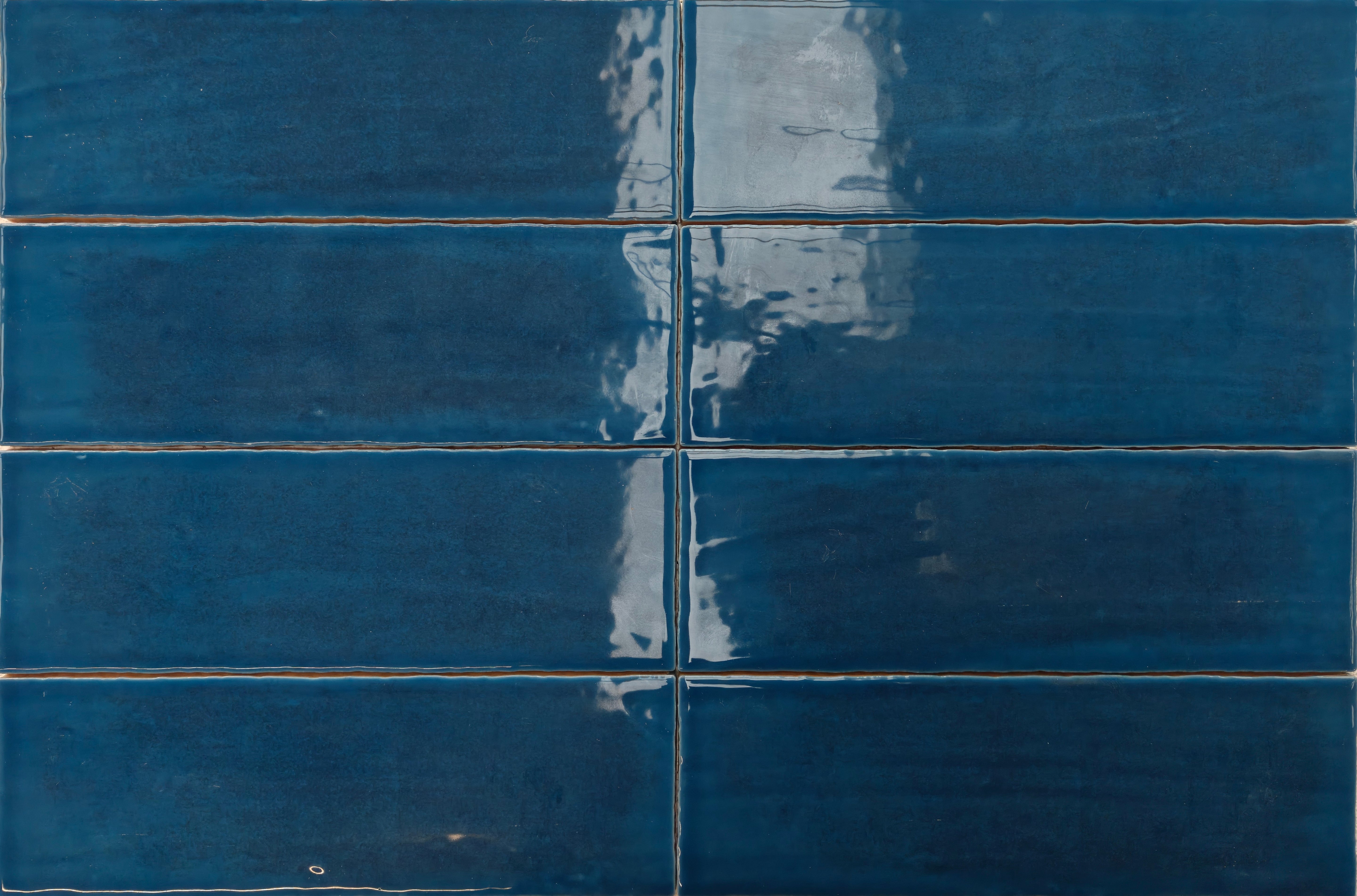Maya Blue 7.5x22.5cm tiles showcasing rich blue glaze and high-gloss finish for a sophisticated wall design.