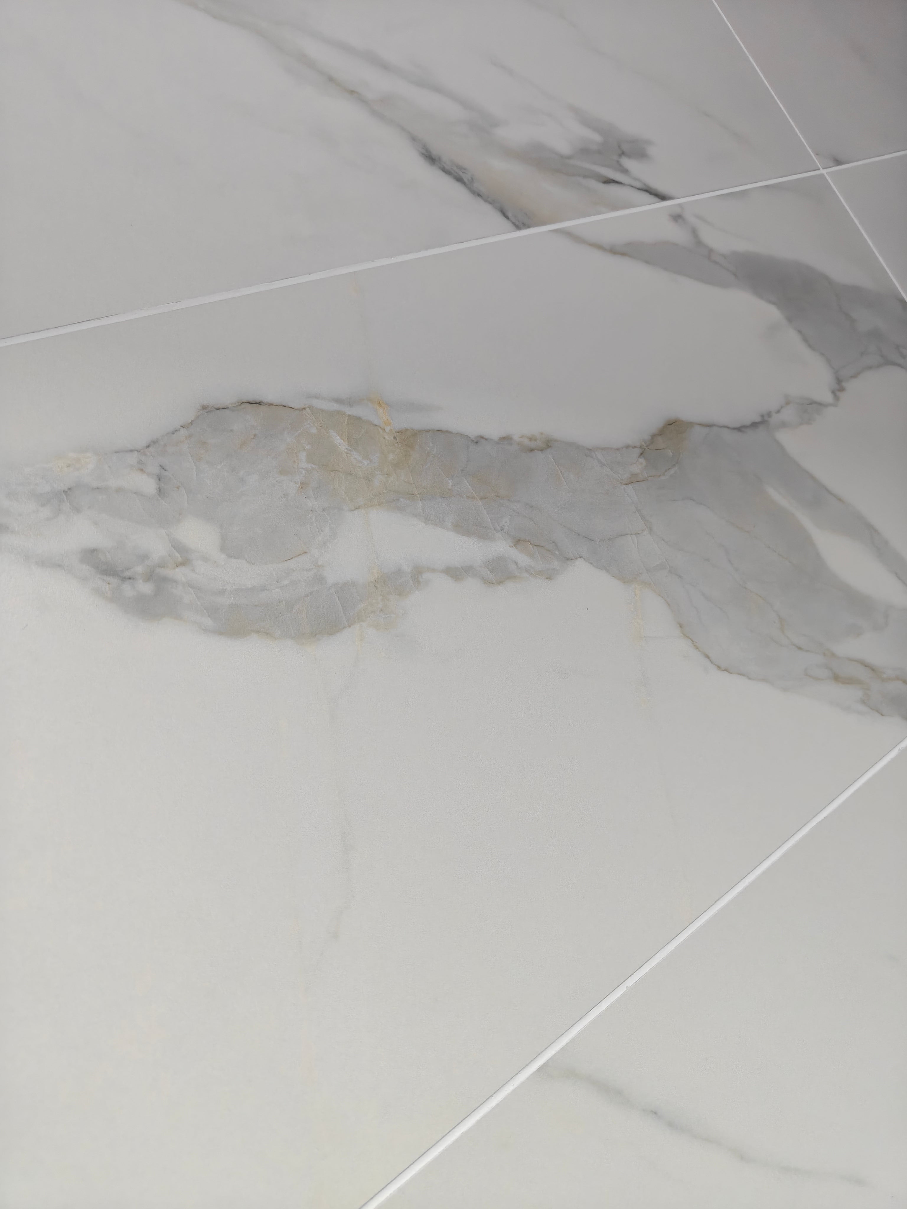 Calacatta Oro Matt with soft white base and gold accents, perfect for luxury interior design.