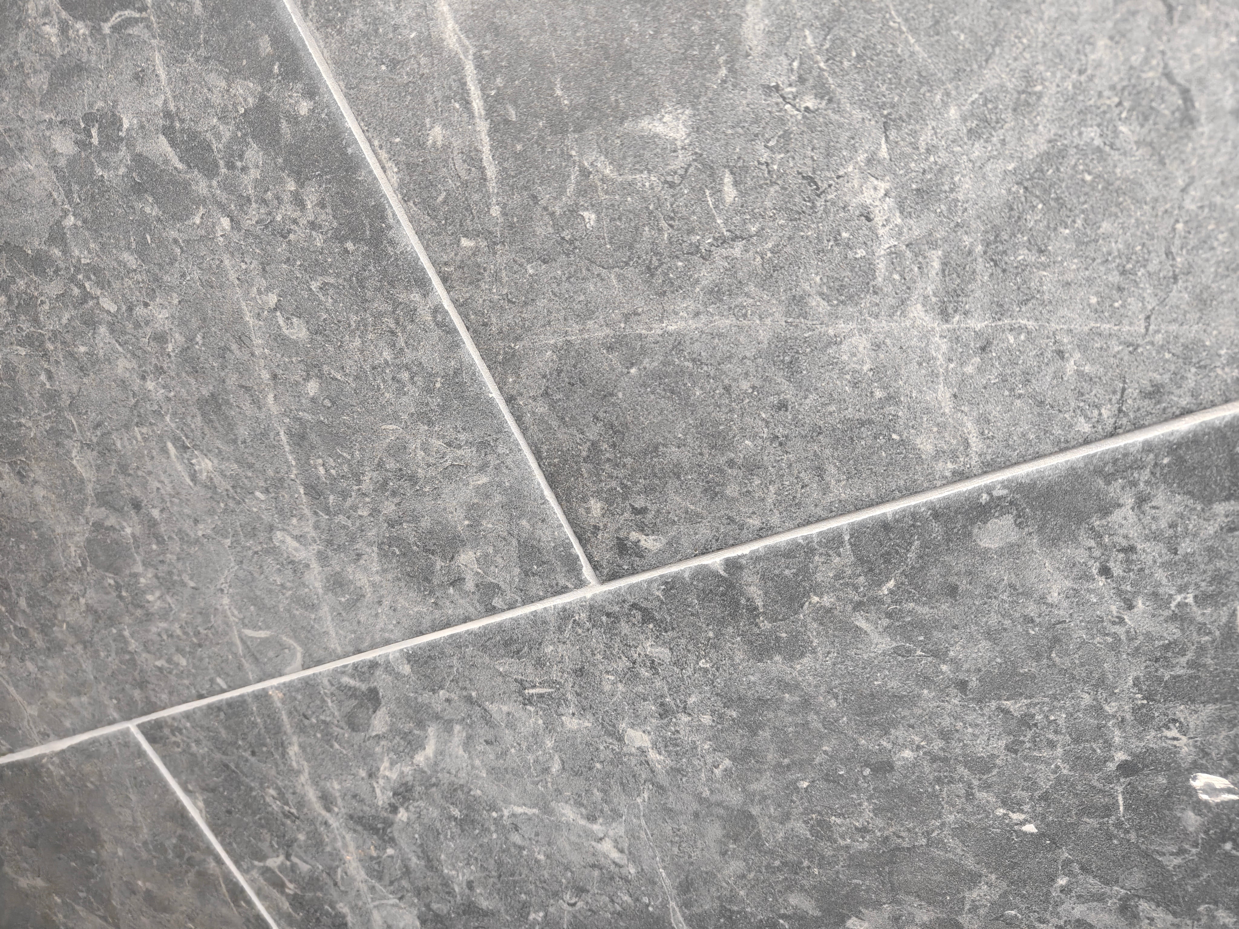 Botticino Dark Grey porcelain tile with soft veining and mineral patterns in a matte finish.
