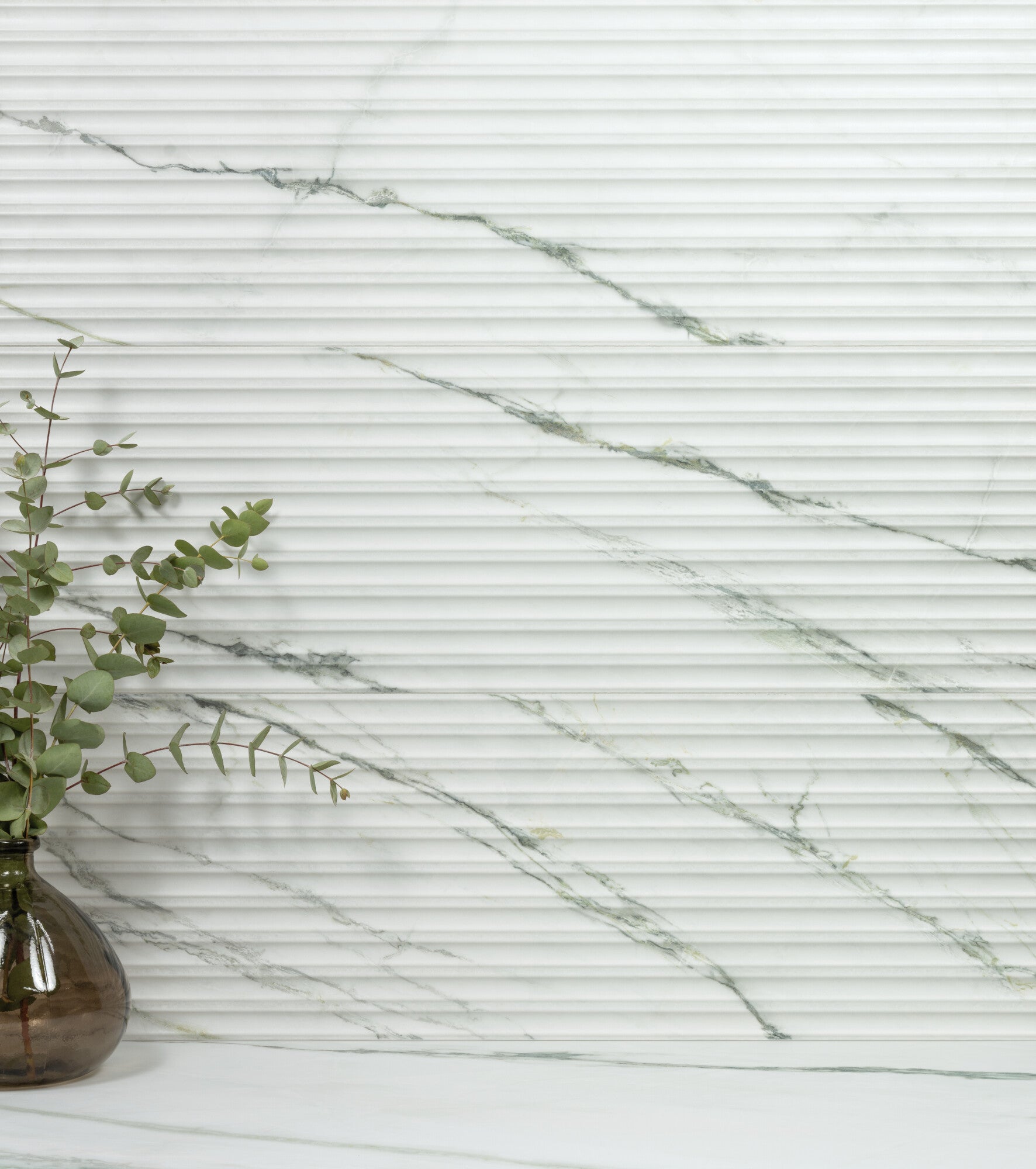 Calacatta Green Lines 33.3x100cm ceramic wall tile with textured surface and green-grey veining.