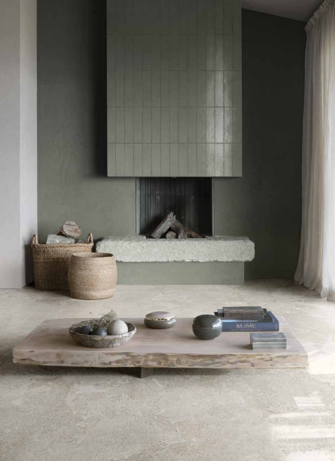 Stylish living room with Ligure Blanco 60x120cm tiles by Marazzi, featuring a modern fireplace and elegant decor.