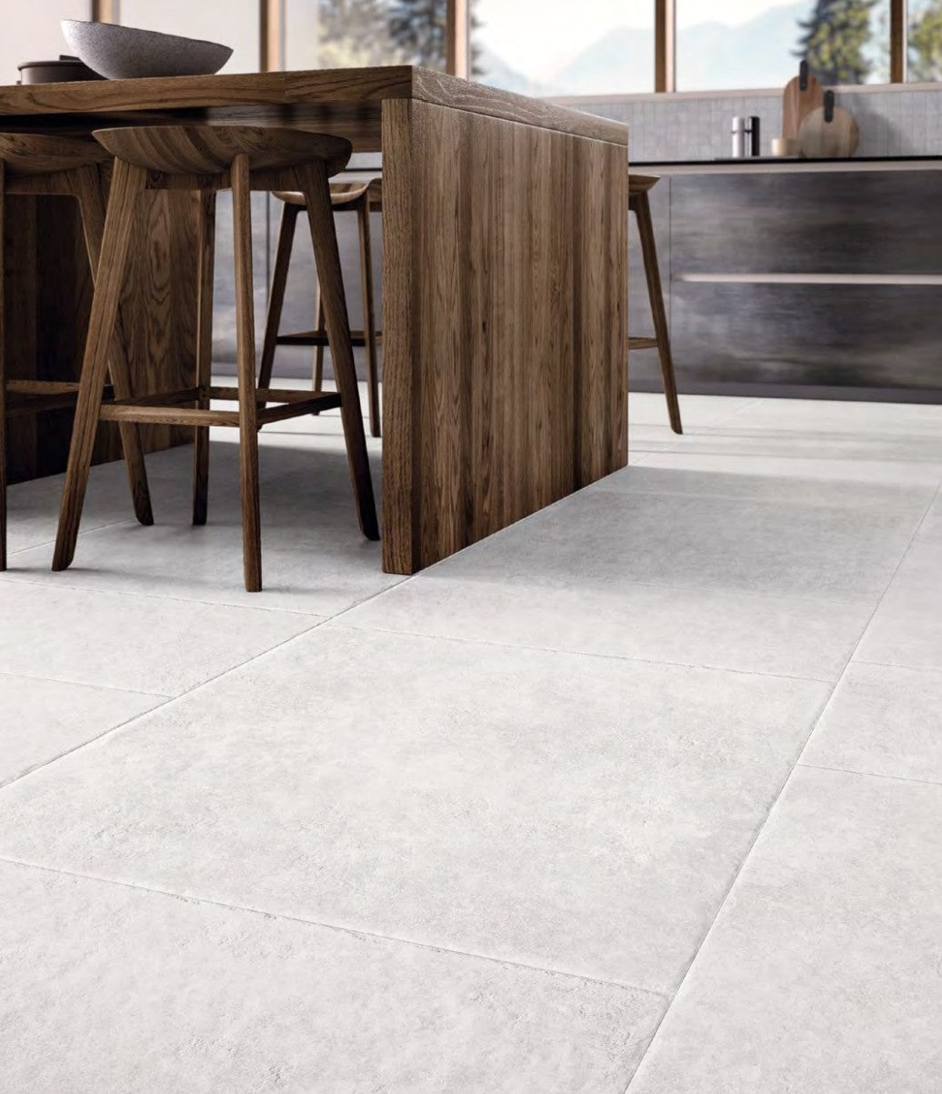 Chateau Blanco 80x80cm porcelain tiles installed in a modern kitchen with wooden furniture.