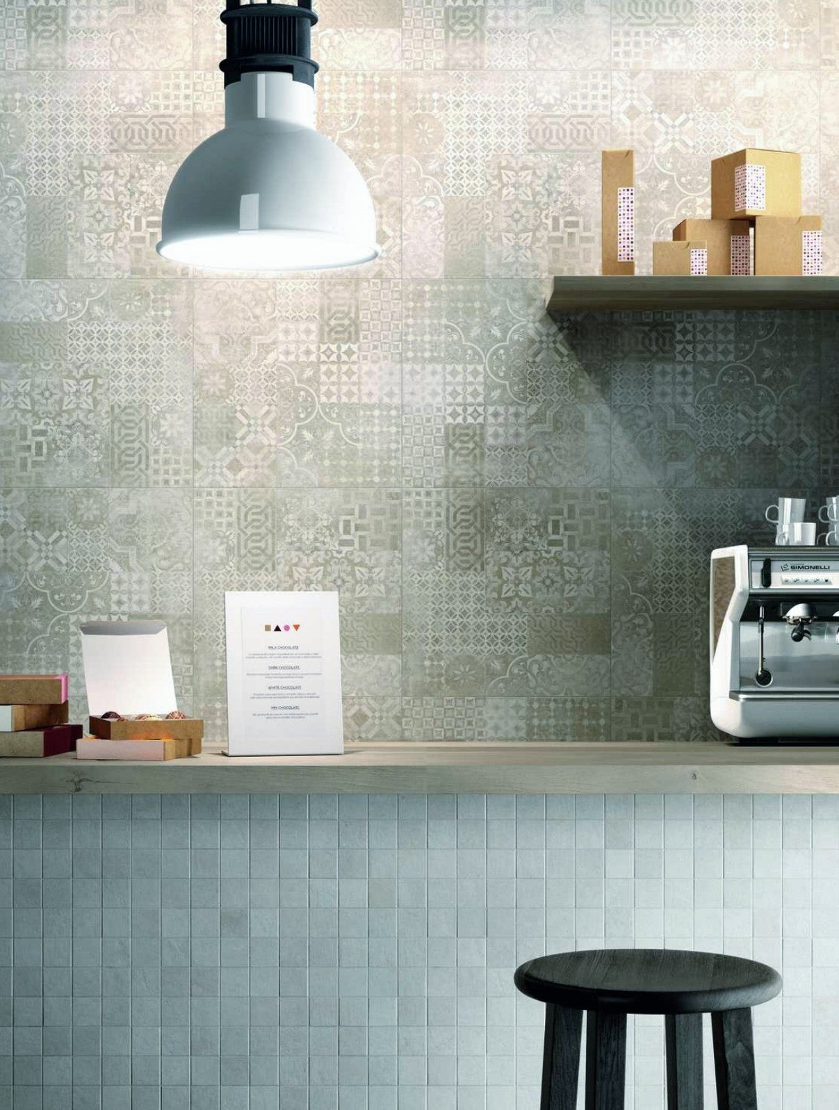 Plaster Decor Greige 60x60cm tile with warm grey palette and patchwork motifs in a modern interior.