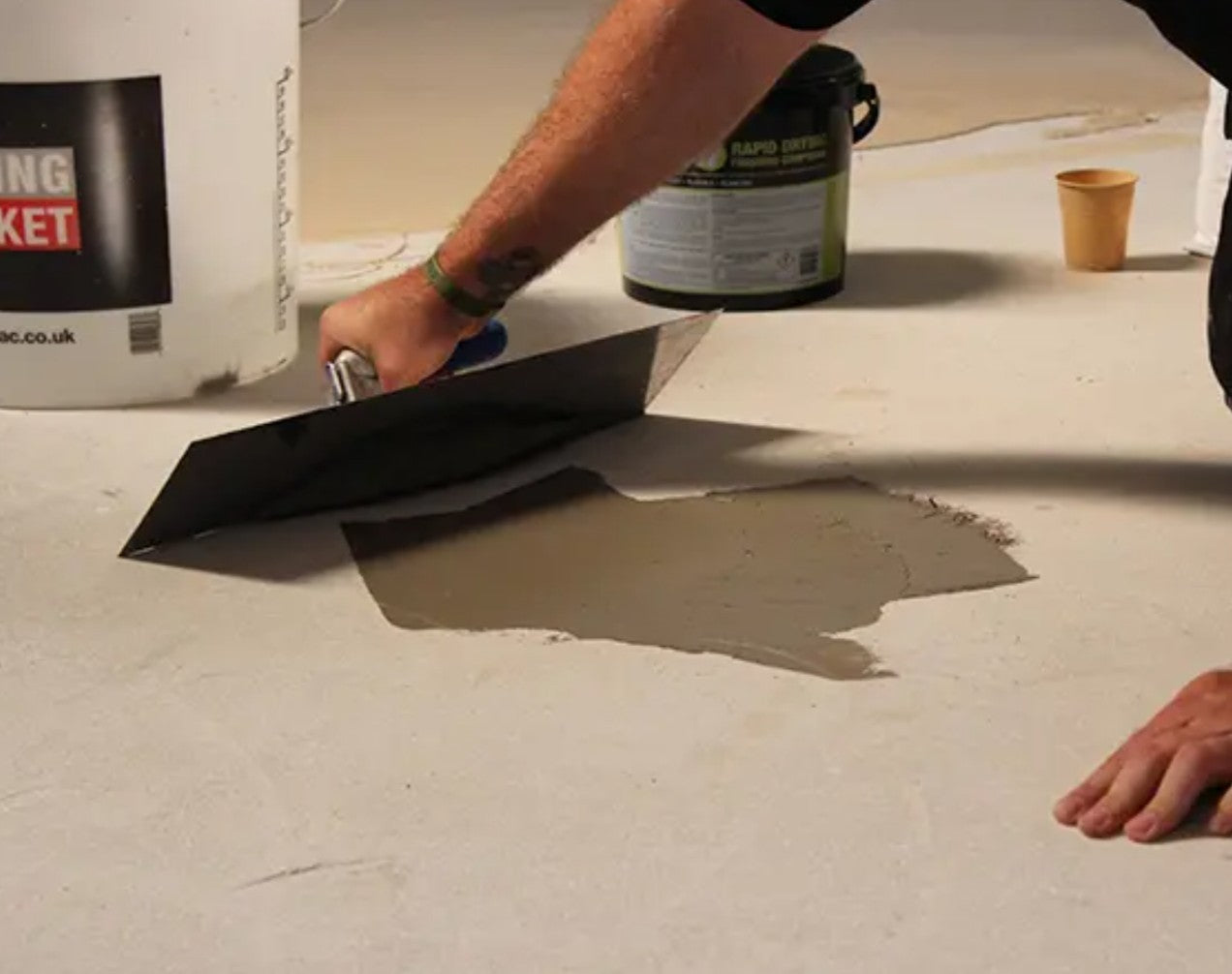 Applying Ultra Feather It 5kg - Feathering Compound to a floor with a trowel.
