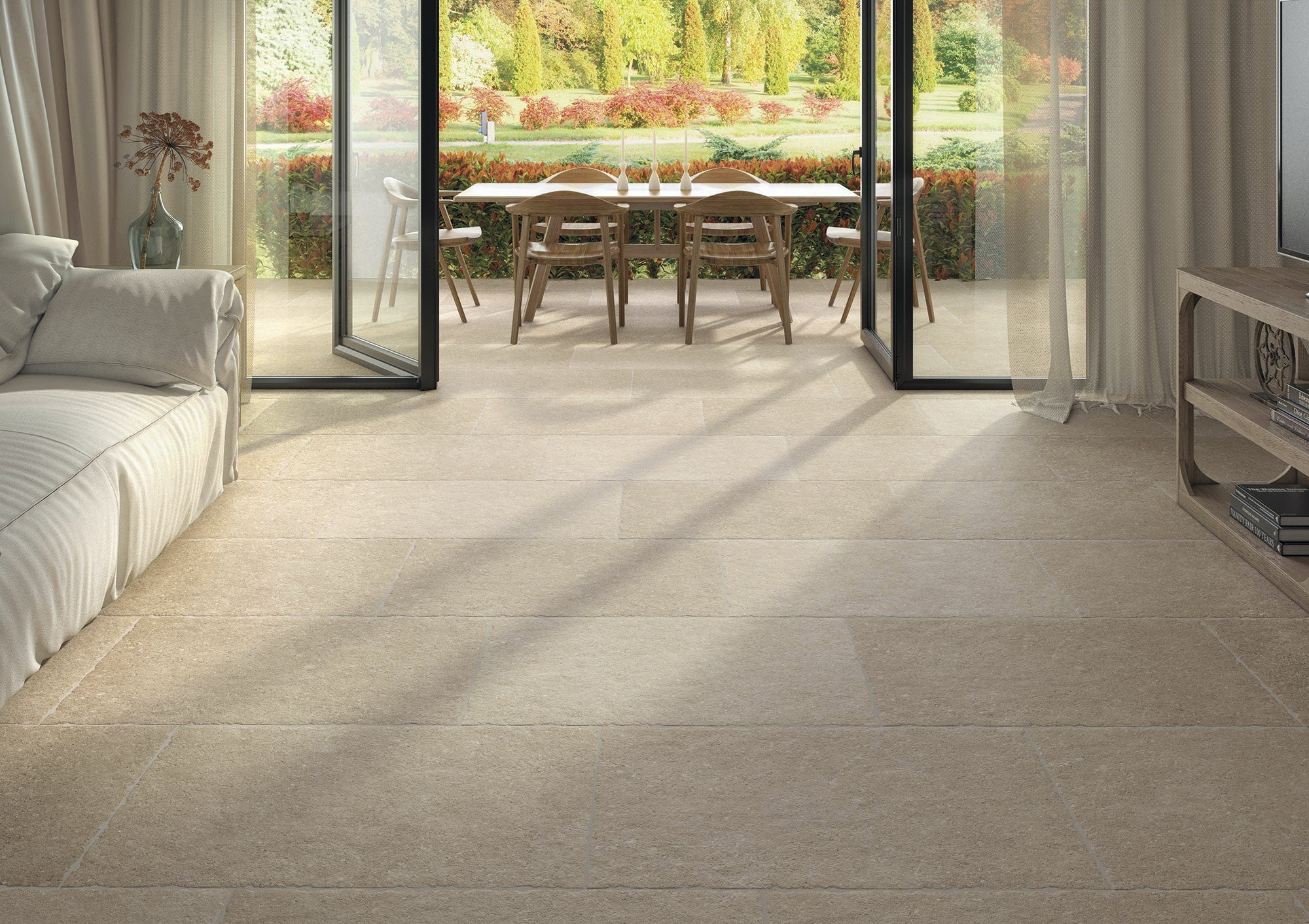 Ette Natural flooring tiles in a contemporary living room with a garden view, highlighting warm sandy hues and refined textures.